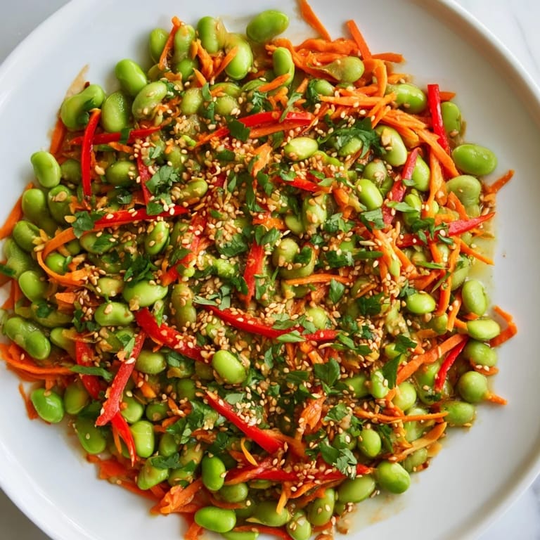 Freshly tossed Asian Edamame Salad, featuring crunchy vegetables and a savory, aromatic glaze.