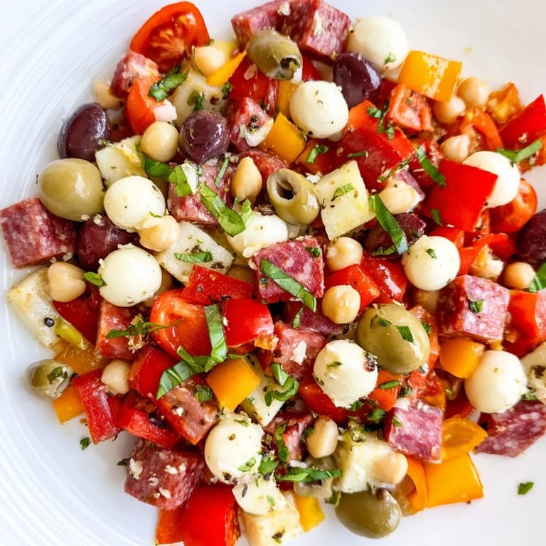 Healthy Italian-American Crunchy Antipasto Chopped Salad with vegetables, olives, and fresh herbs, perfect for a light lunch.