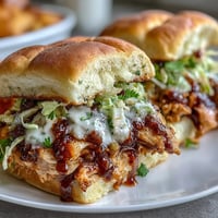 Juicy Mississippi chicken sliders topped with creamy coleslaw, served on soft buns for a satisfying meal.  