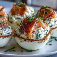 Smoked salmon deviled eggs with everything seasoning, garnished with dill and extra salmon for a gourmet appetizer.